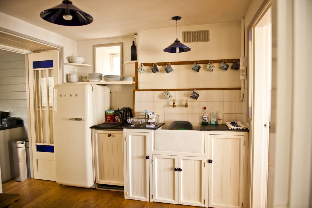 The Sundial's kitchen with the fridge and crockery