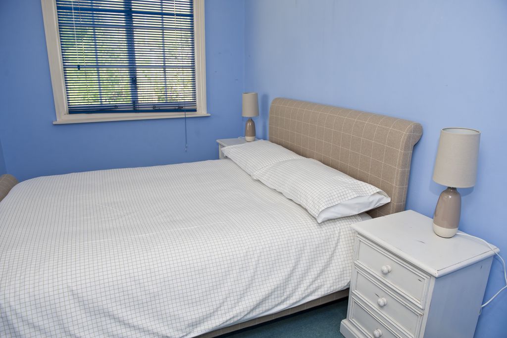 Second bedroom with double bed and blue walls