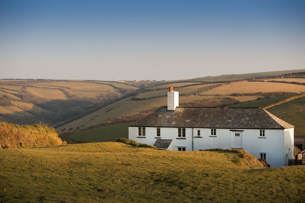 Cornish cottage amongst the fields in the sunset