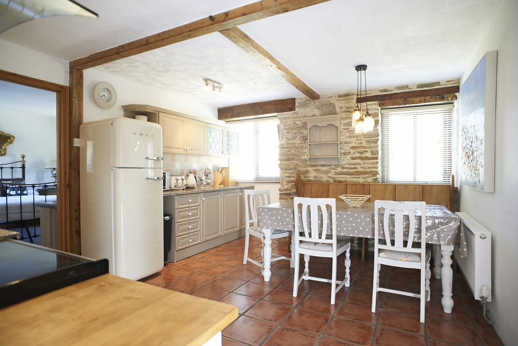Open plan ktichen and dining area with modern appliances and a Smeg fridge