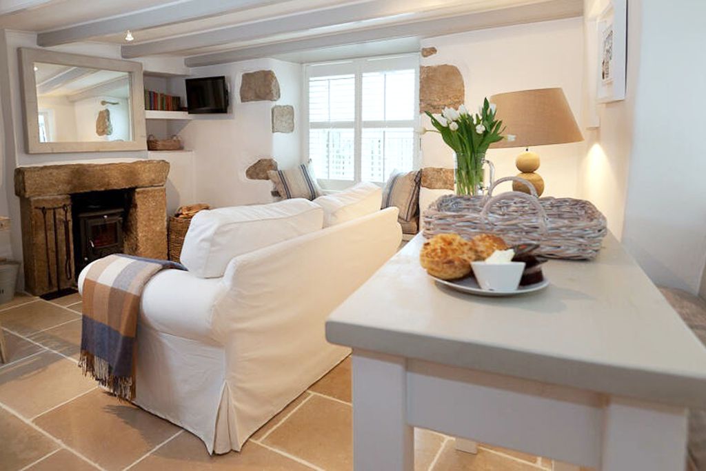 Cottage living room with traditional fireplace and log burner 