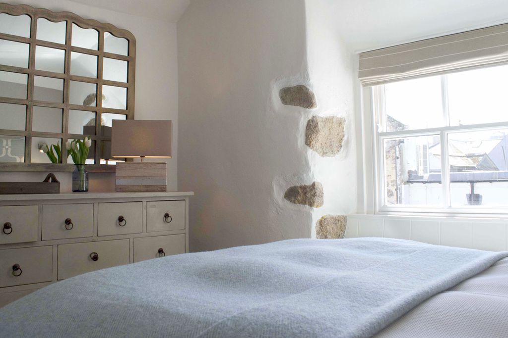 Cosy double bedroom with fresh flowers on the side table