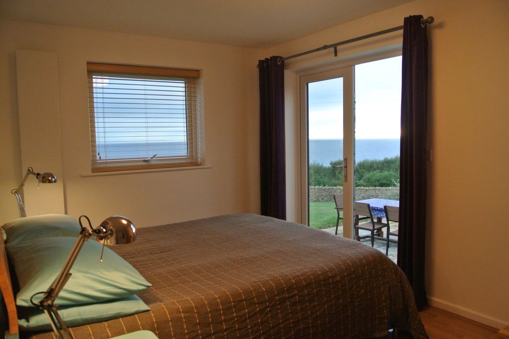 Stylish double bedroom with a view of the sea from the window