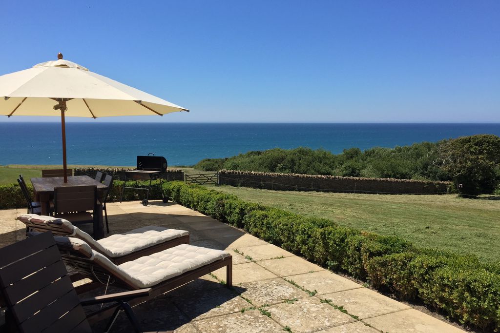 Deck chairs in the garden looking out to sea