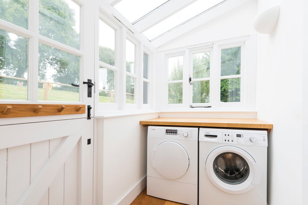 Utility room with washing appliances and door to the garden