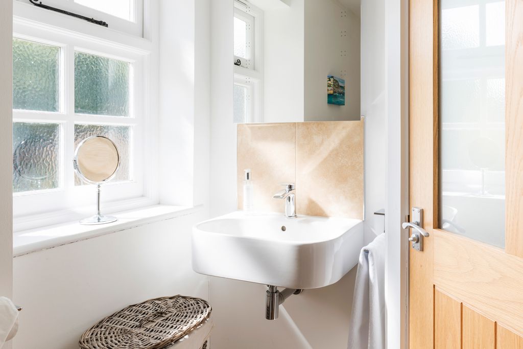 Naturally lit bathroom sink and mirror