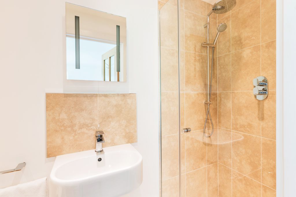 Crisp stylish bathroom with sink and shower