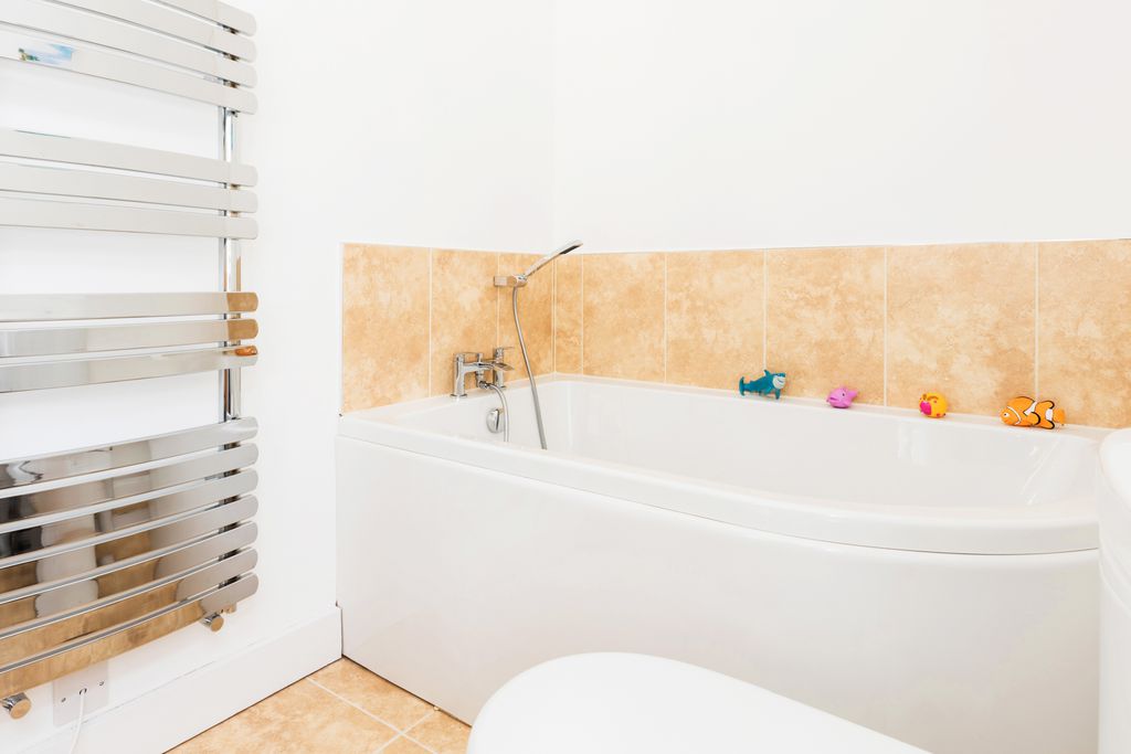Bathroom with bath and shower head