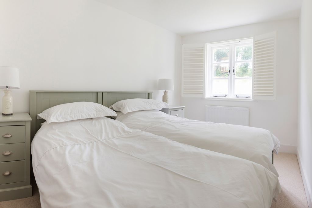 Stylish bedroom with two single beds