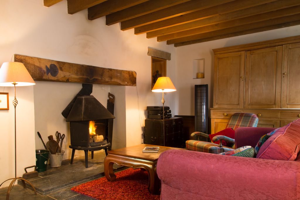 Sitting room with the fire alight at Crofters Cottage