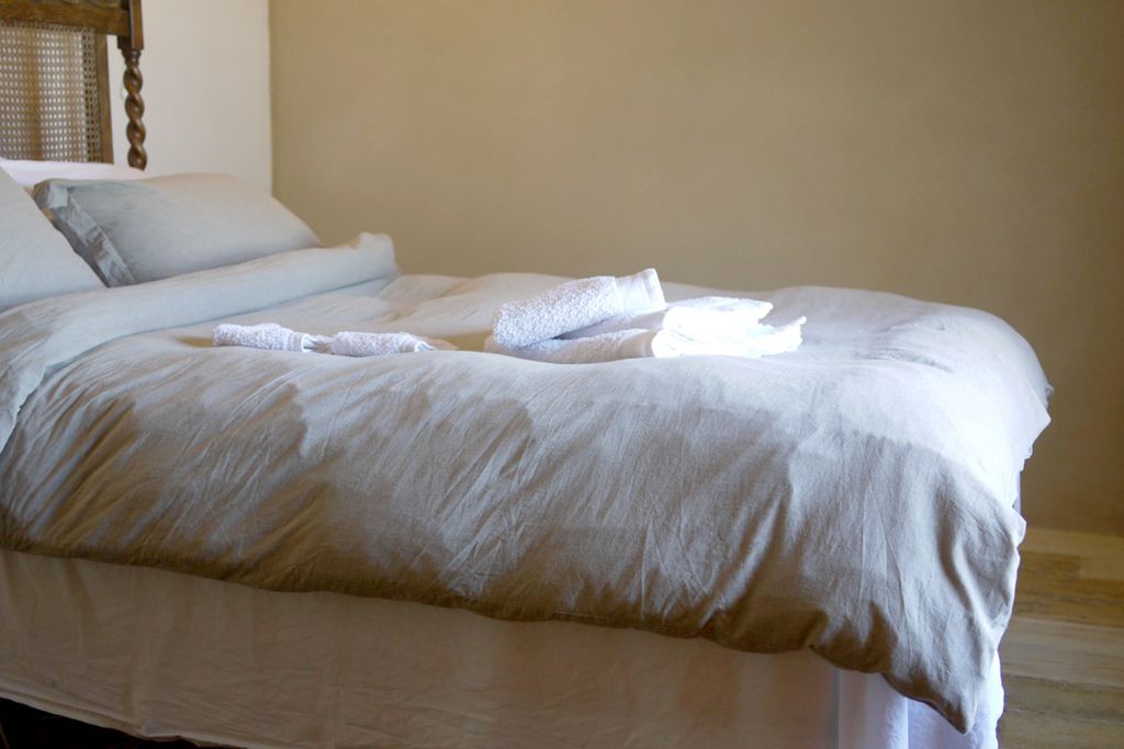 Cosy double bedroom with fresh linen on the bed