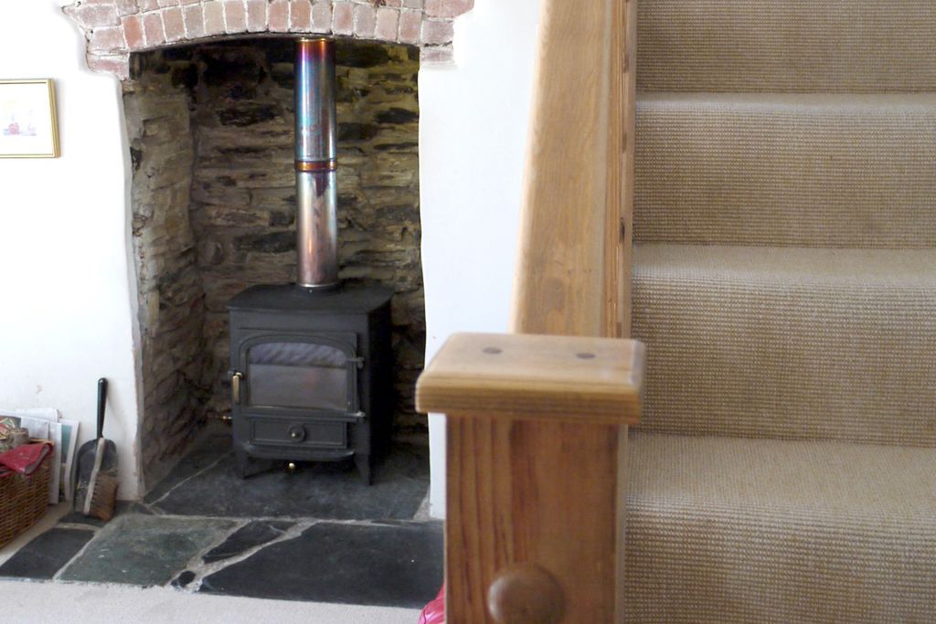 Cosy lounge with flagstone hearth and log burner