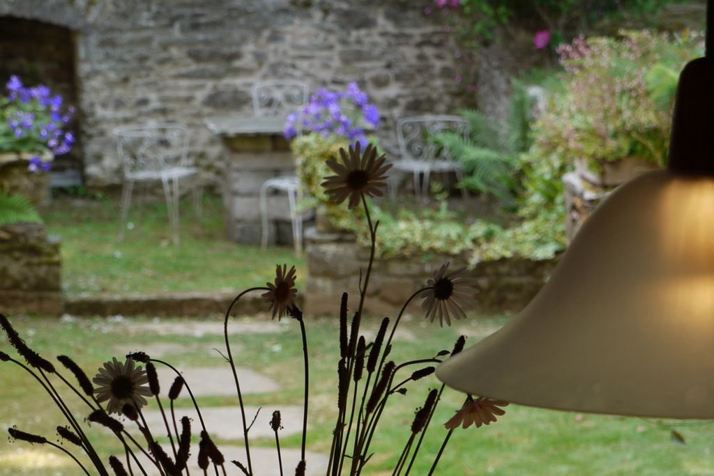 Looking out from the property into the garden with an outside seating area