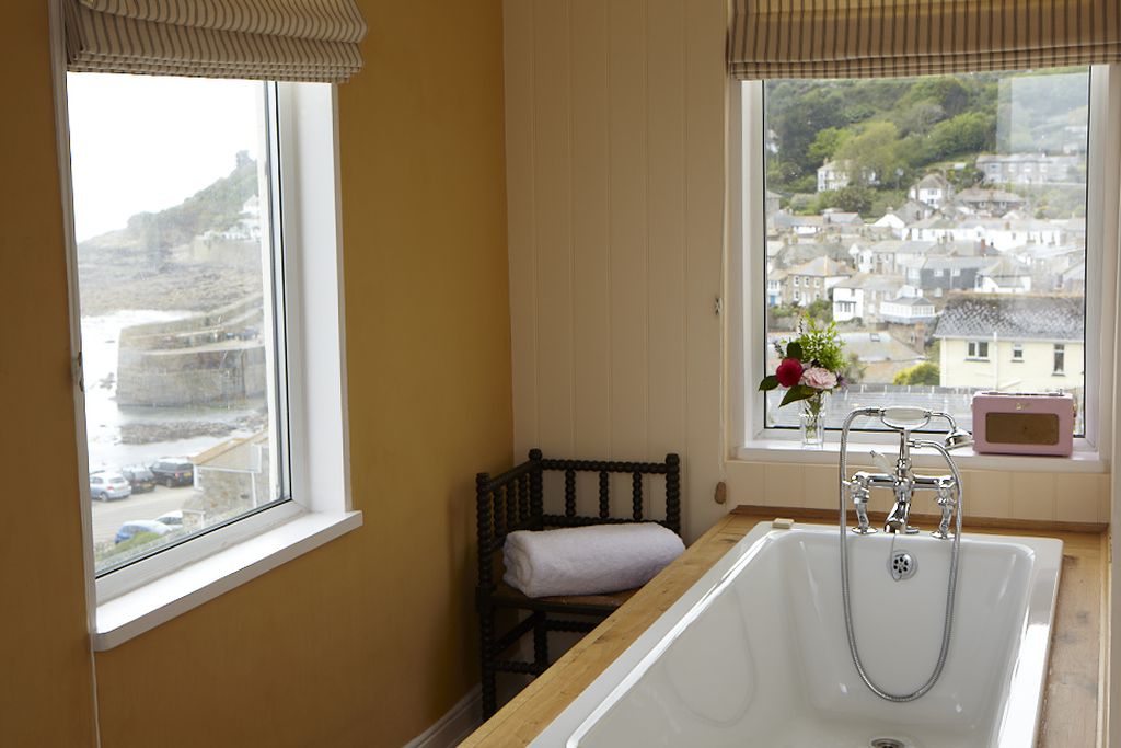 Bath with windows overlooking the coast