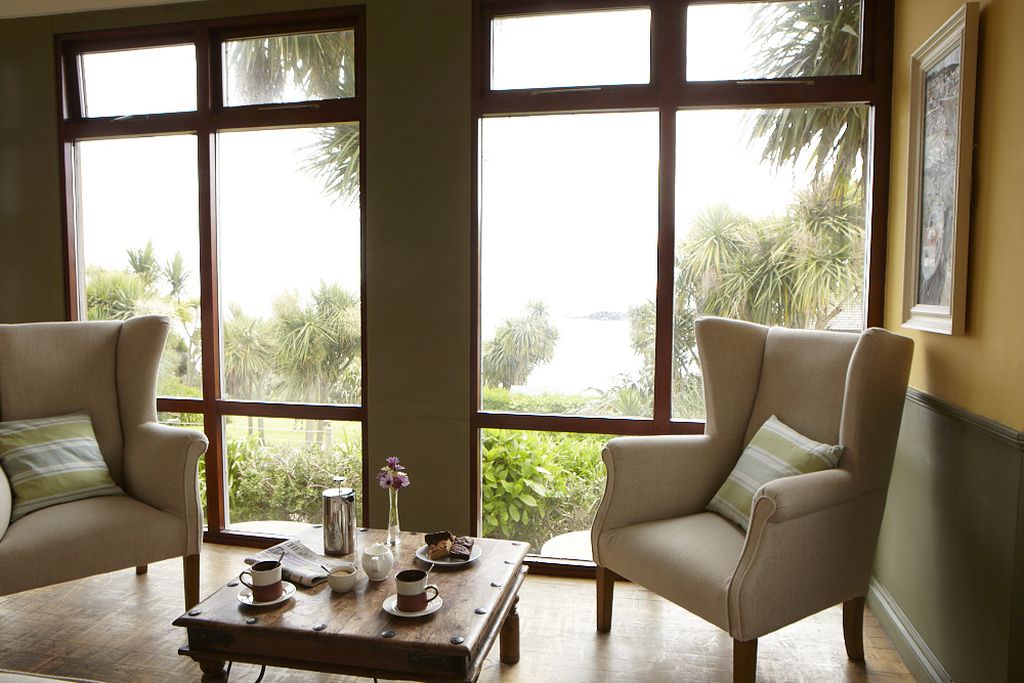 Seating area with tea and cakes, overlooking the garden and coast
