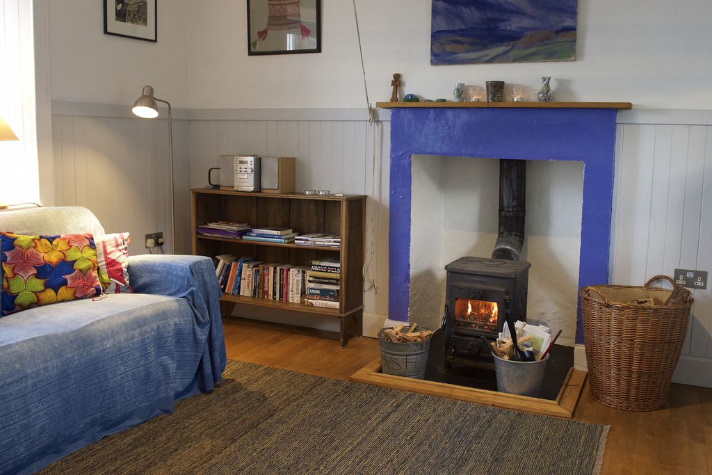 Sitting room with fire burning in the log burner