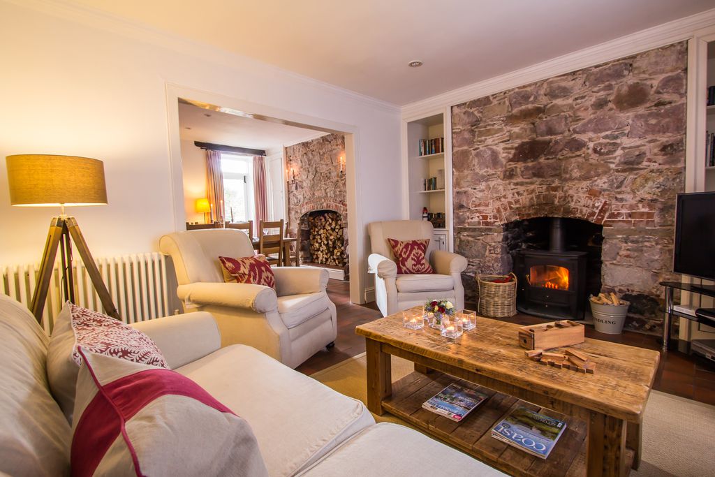 Cosy sitting room with fire burning at Blue Monkey in Cornwall
