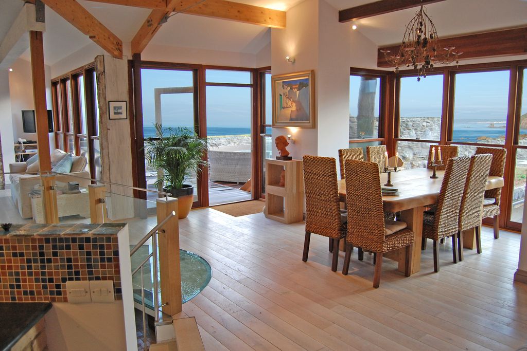 Open plan first floor containing dining room and living room with amazing views out to sea