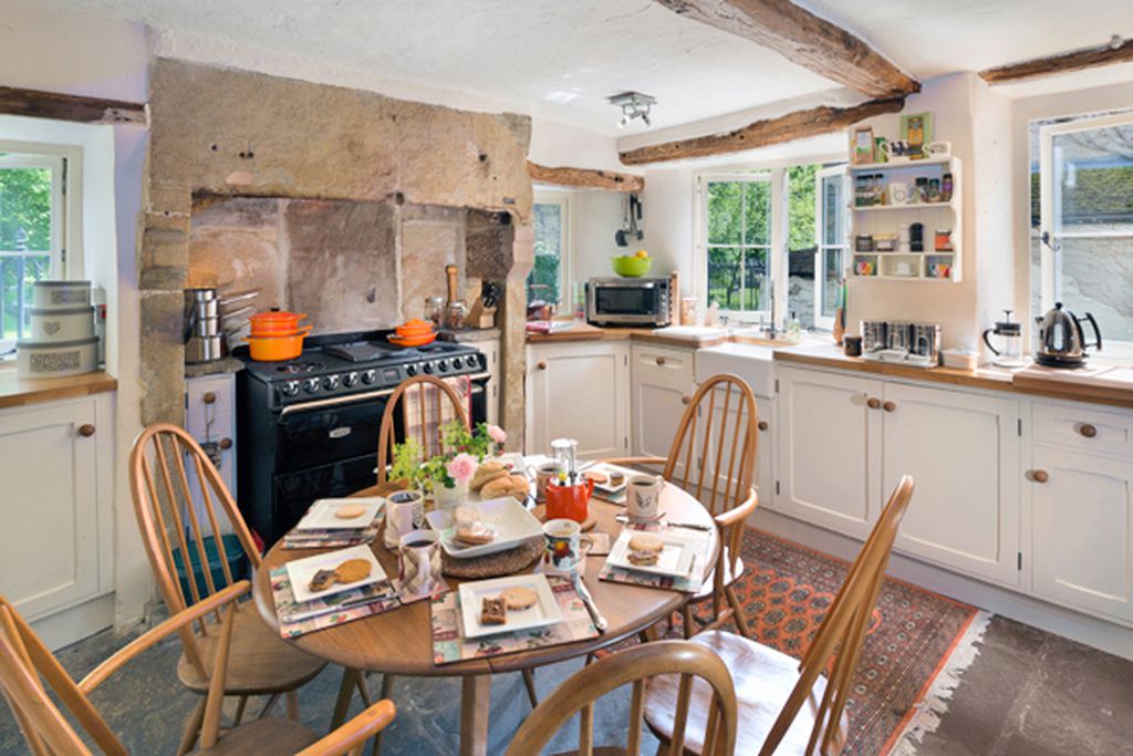 Kitchen with aga and table made up for breakfast