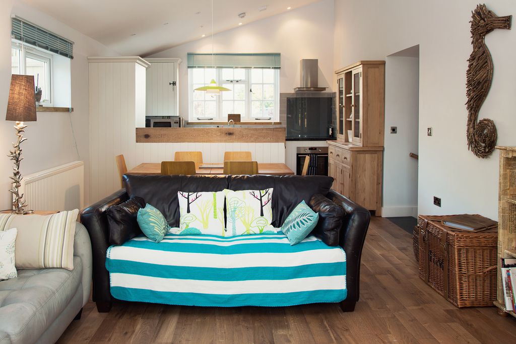 Main living area with kitchen and dining table behind