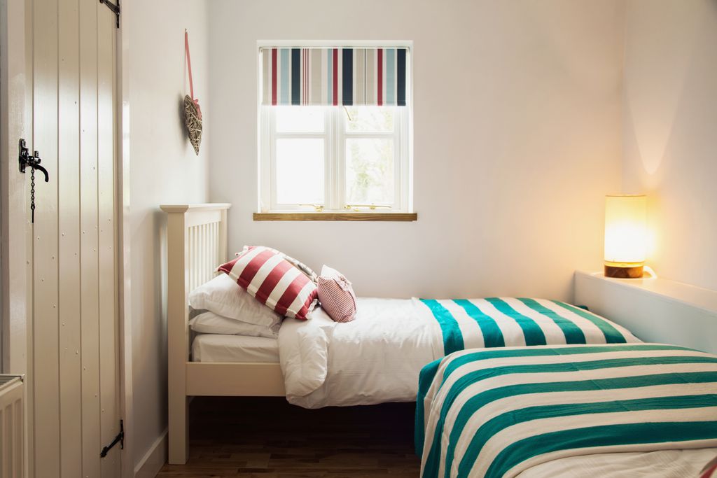 Bedroom with two single beds and green and white blankets