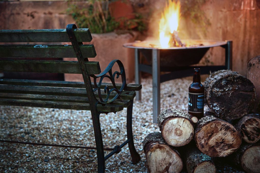 A bench and a burning fire in the garden