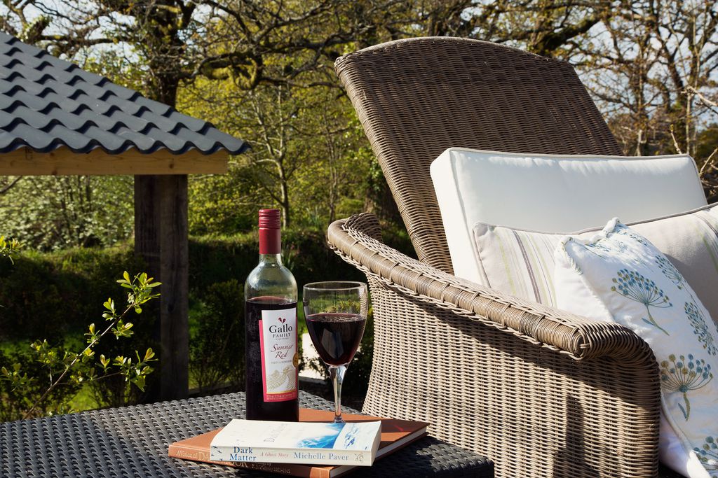 Outside chair with cushions and wine