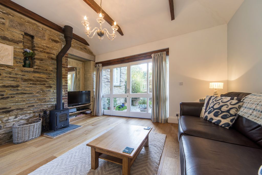 Cosy sitting room at Bolotho Barn, Bramblings in Cornwall with log burner