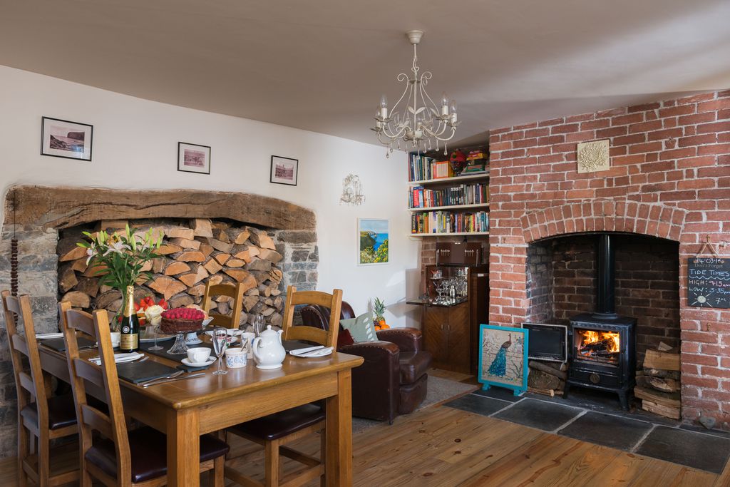 Dining room at Trevigue in Cornwall with cake and champagne on the table