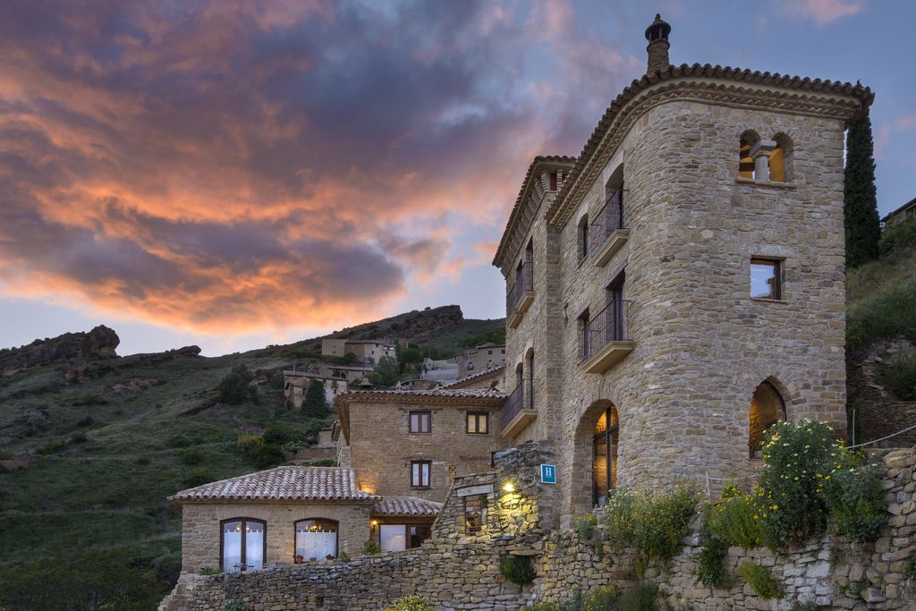 Exterior view of the Heredad Beragu Navarra, Spain and the surrounding hills.