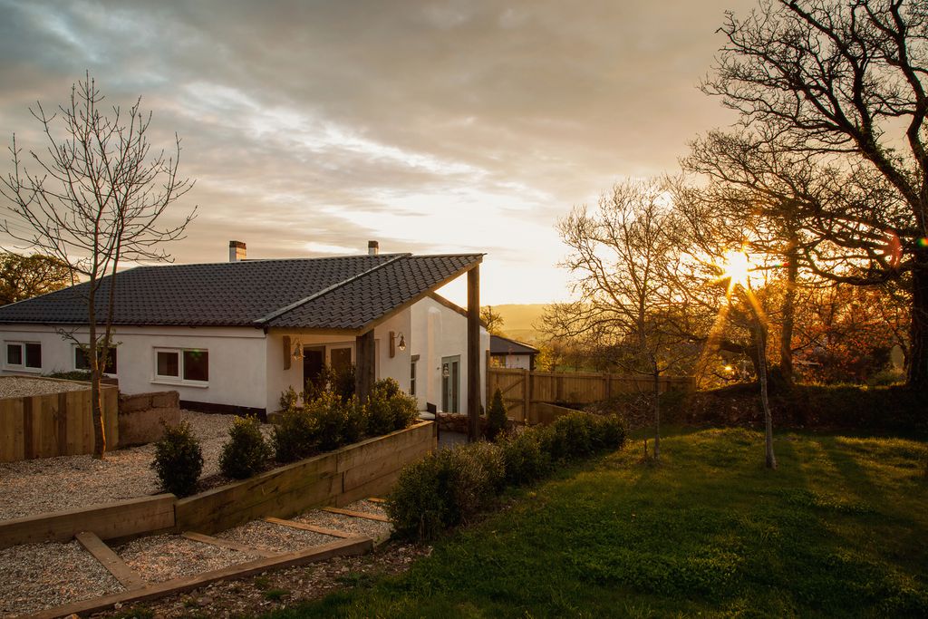 Burrow Wood Farm Devon, exterior view of the property with a sunset view