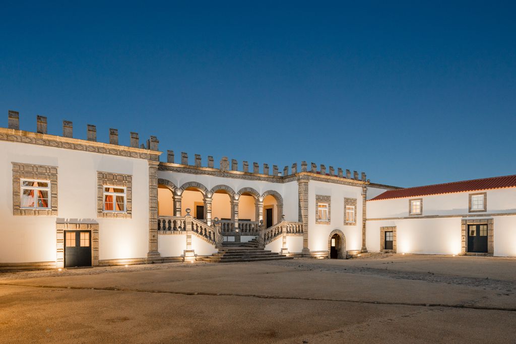 Exterior view of Paco de Vitorino, Ponte de Lima Portugal, white walls, tiles on the roof tops, internal courtyard, beautifully lit at dusk