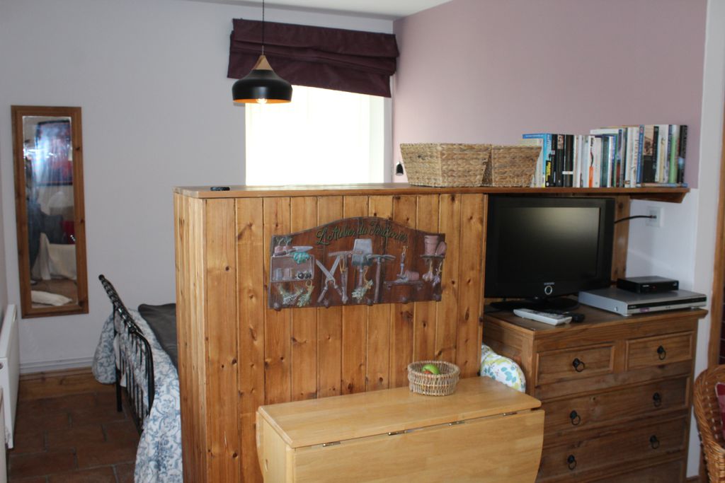 Television in the living room leading onto the bedroom