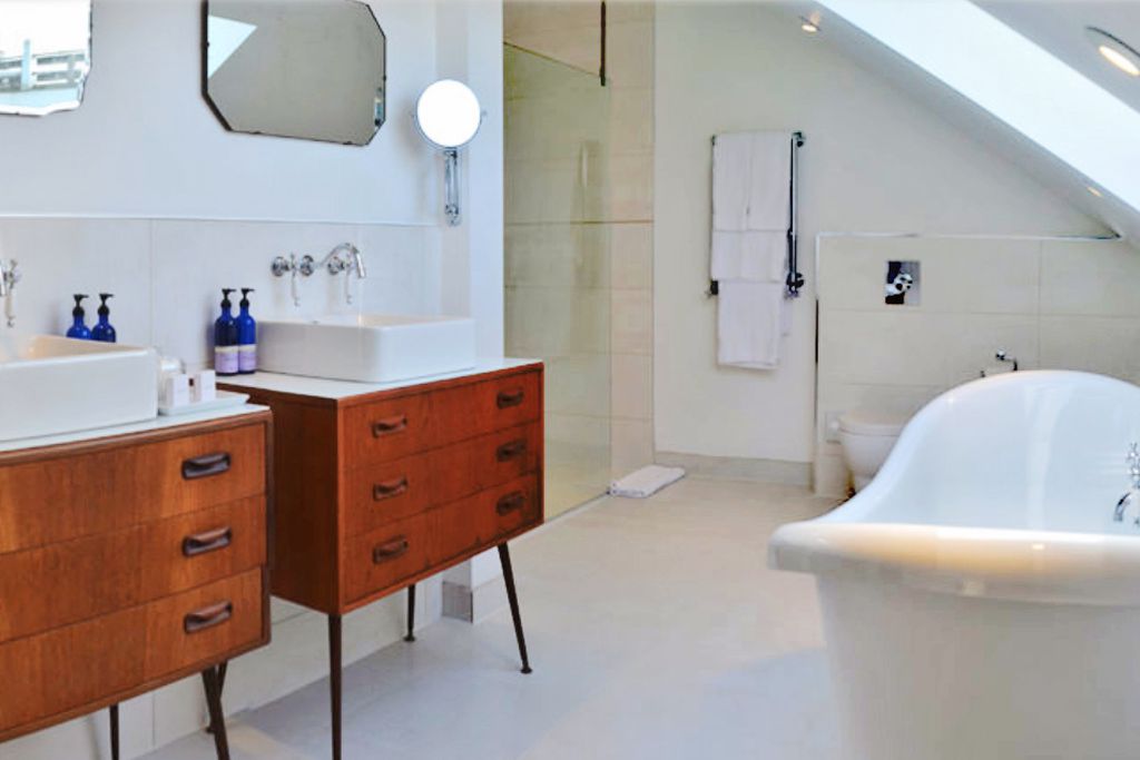 Large bathroom with double sink and freestanding bath tub