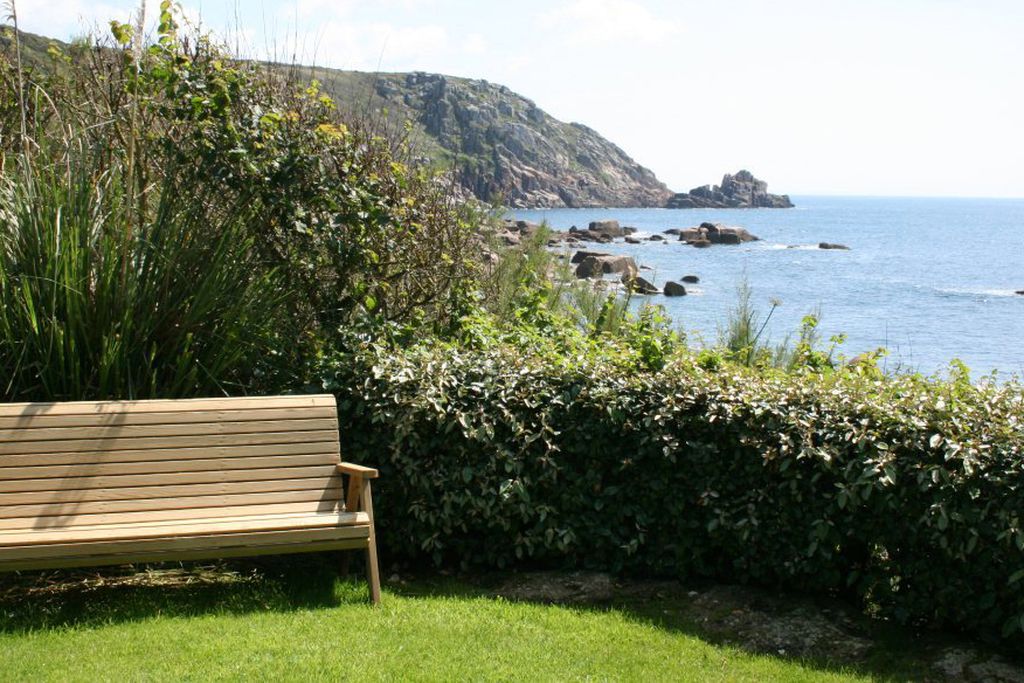 Bench at the bottom of the garden looking out to sea