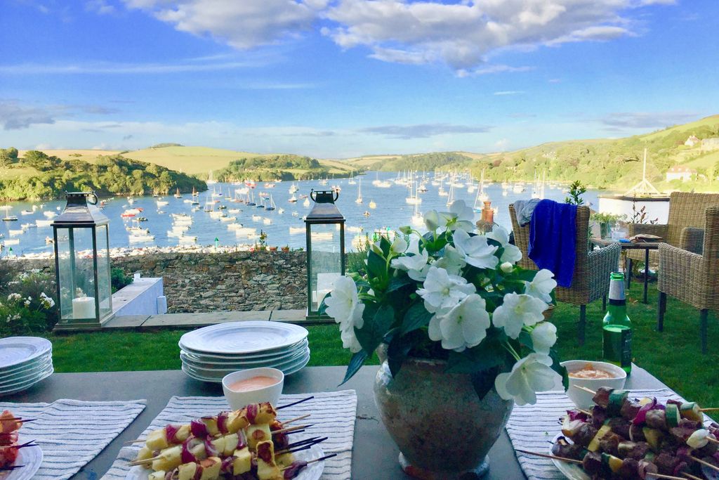 View of Salcombe Harbour from garden at Pitchford House in Salcombe, Devon with table laid for al fresco dining