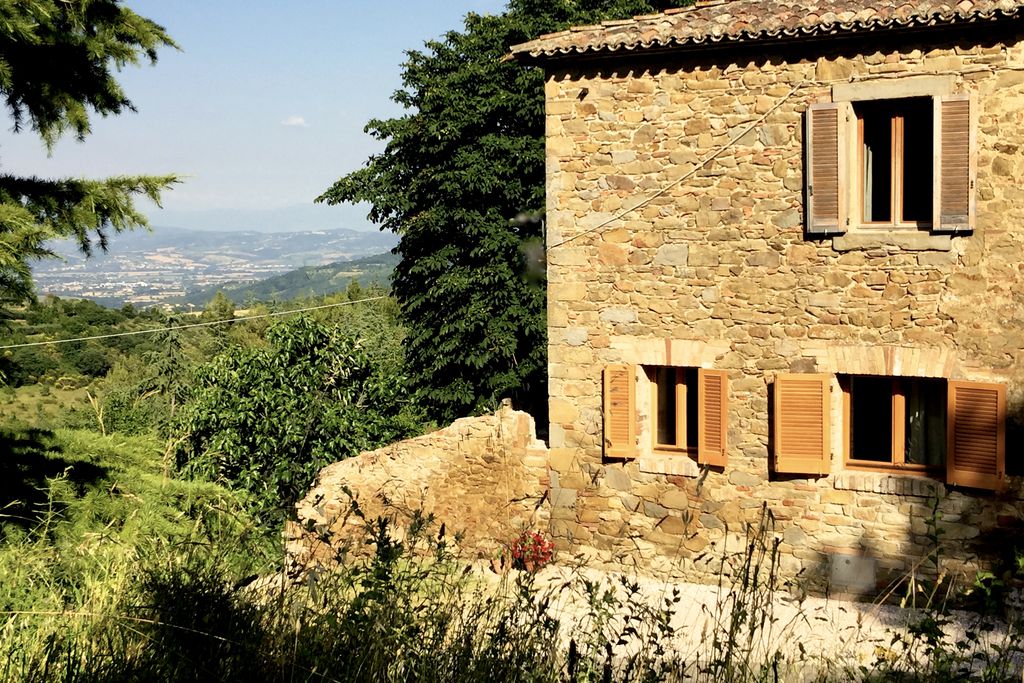 Exterior of Casa sul Monte in Umbria, Italy with views across the mountains and surrounding landscape
