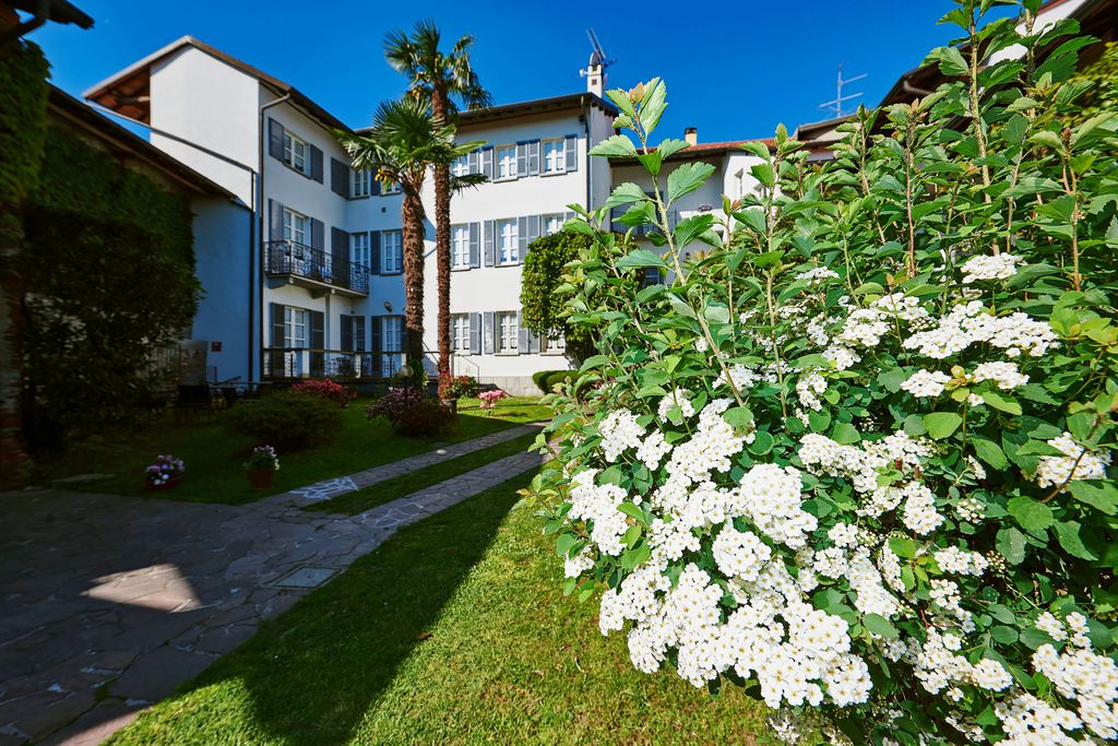 Exterior of Antica Casa Balsari in Novara, Piedmont, Italy with a lovely sunny garden at the front of the property