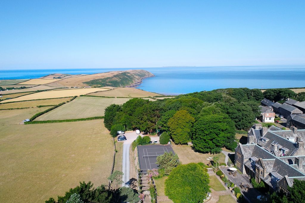 Amity in Georgeham, Devon surrounded by lush green fields and a view towards the turquoise sea in Devon