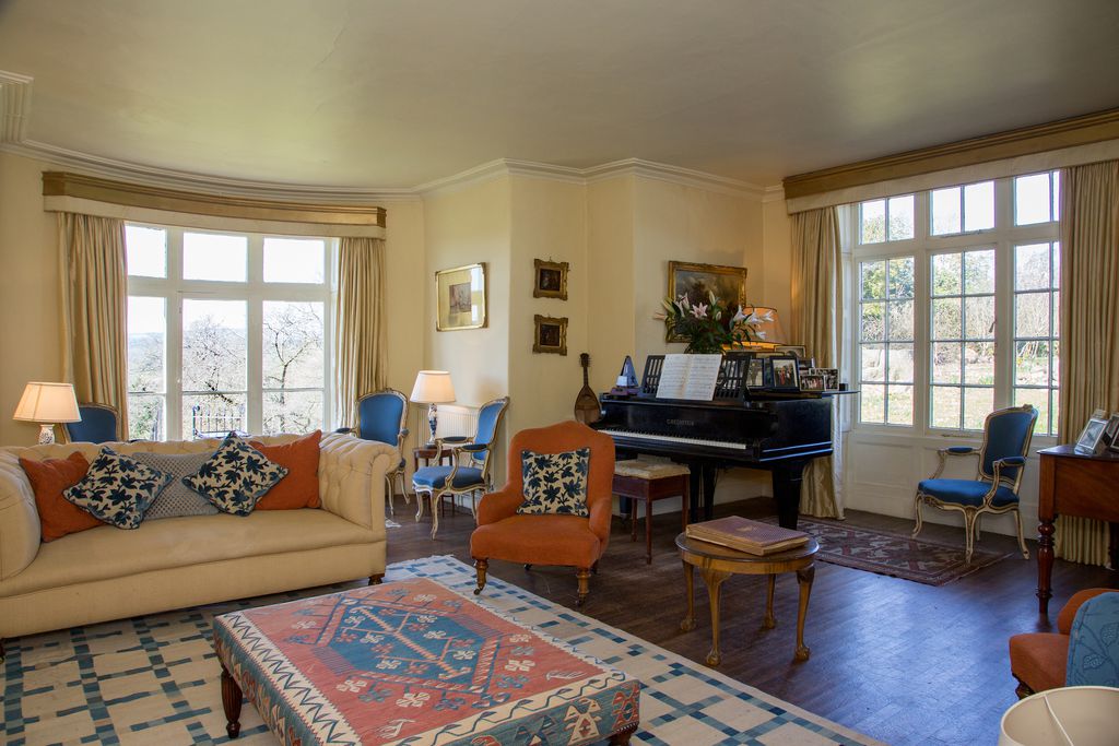 Living room area inside of The Brow with a grand piano