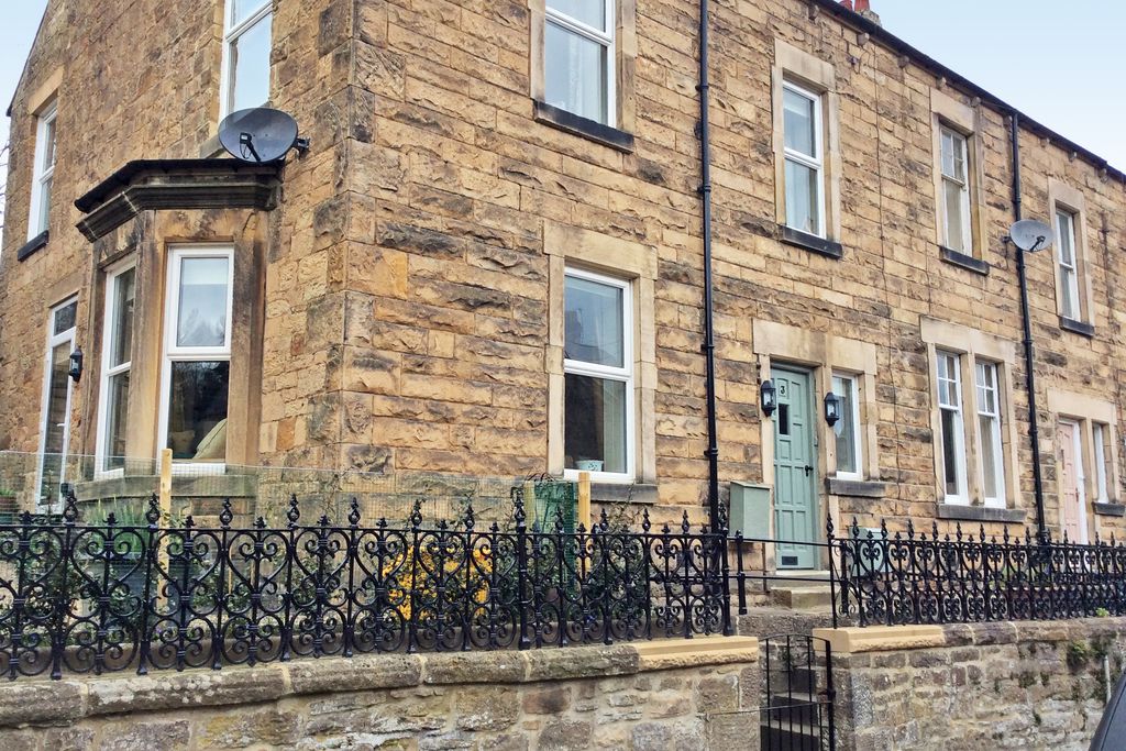 Exterior of Ada Crescent in Northumberland, with steps leading up to the pastel blue front door