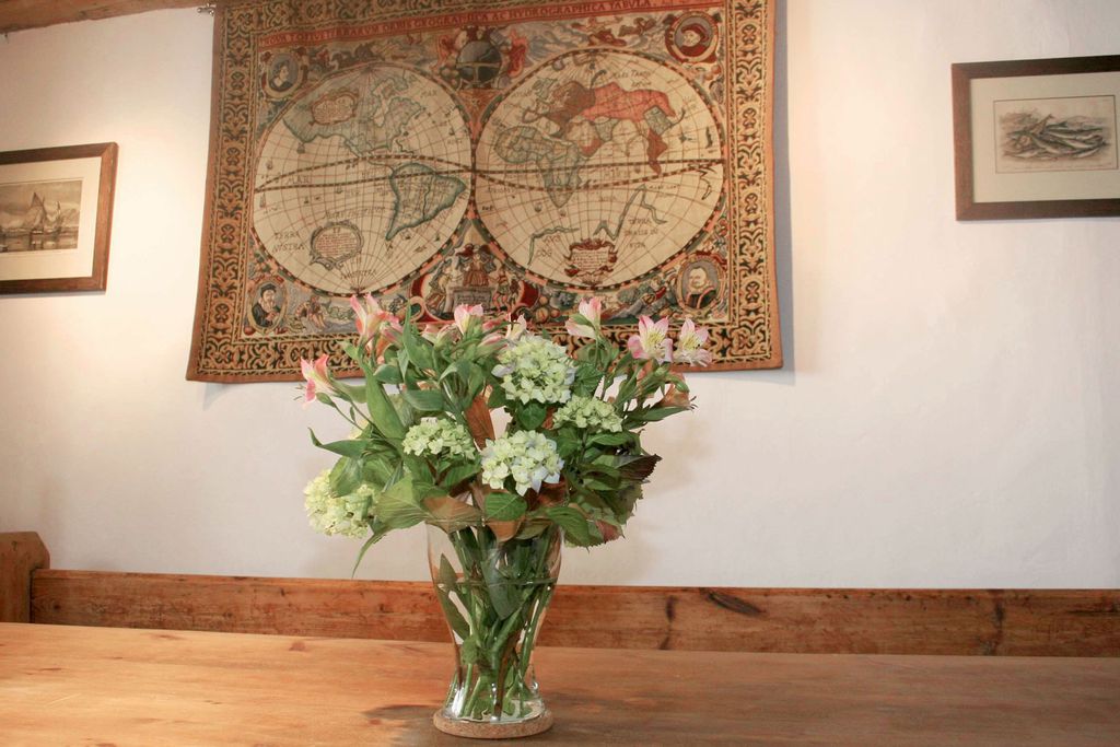 Flowers on the table with globe tapestry on the wall