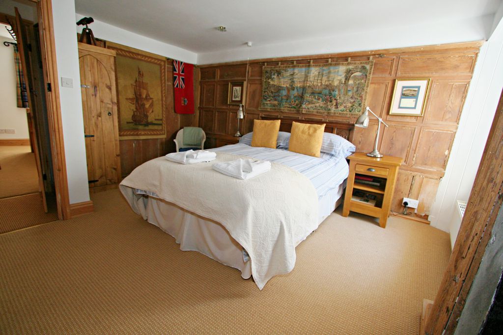 Large double bedroom with towels ready on the bed