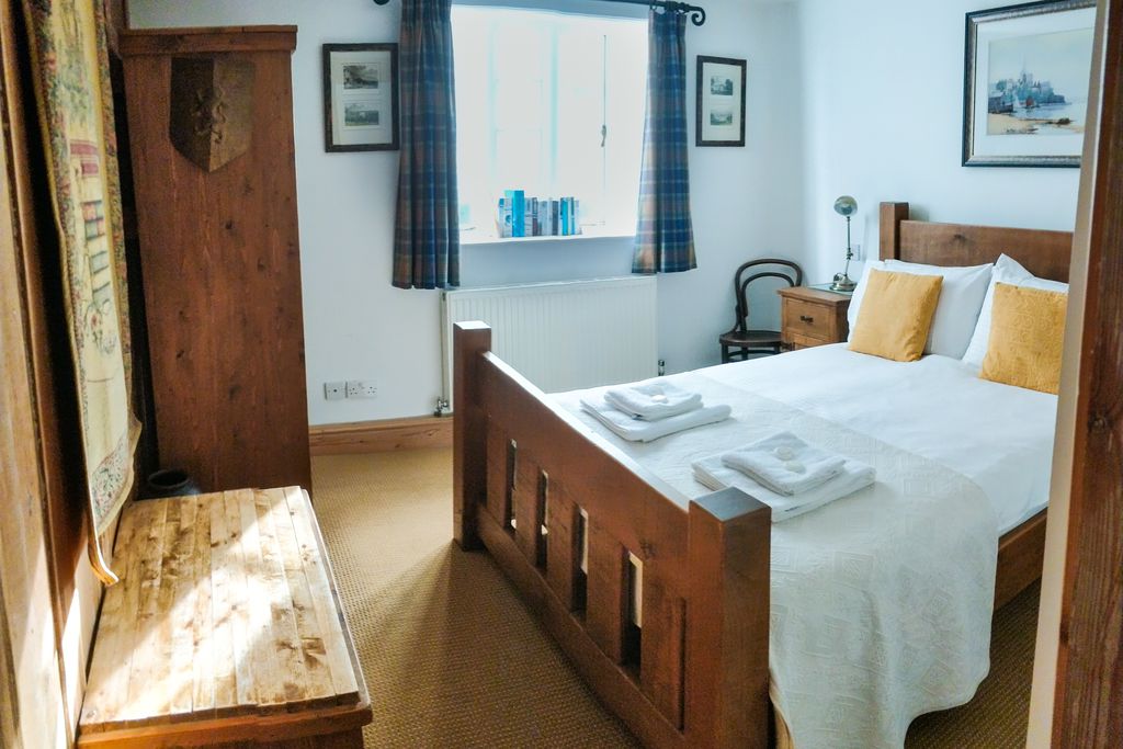 Double bed made up with towels and wardrobe