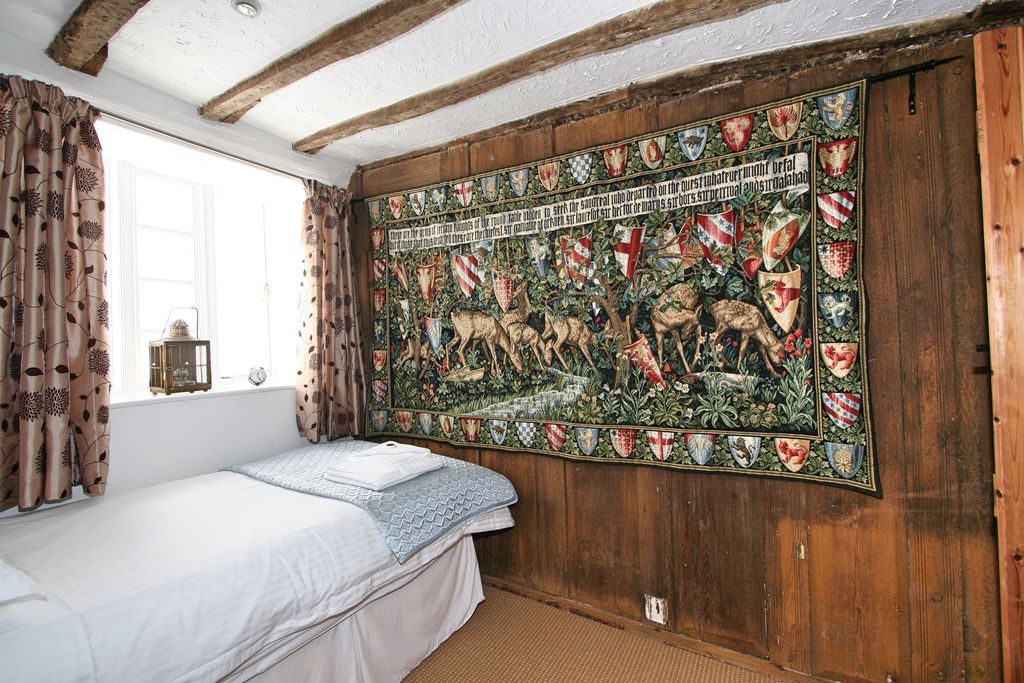 Large tapestry at the end of the bed