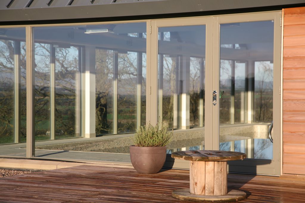 Double doors from the pool area leading onto the outside decking