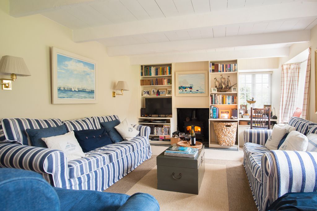 A warm Cornish living room with red wine and a woodburner