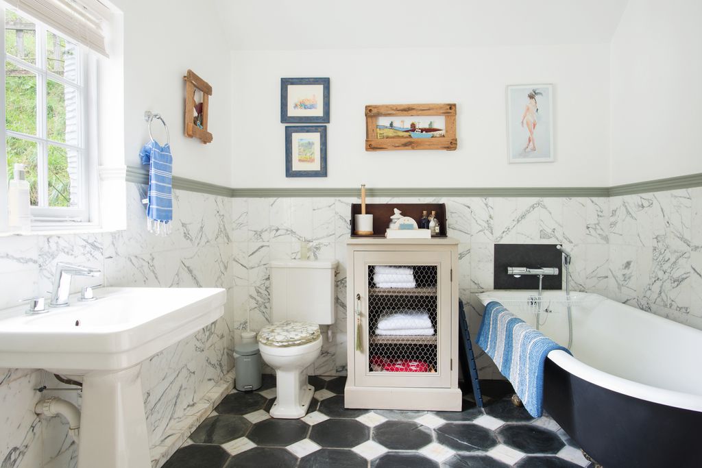 Penpoll's lovely bathroom with tiled floors and a large bath