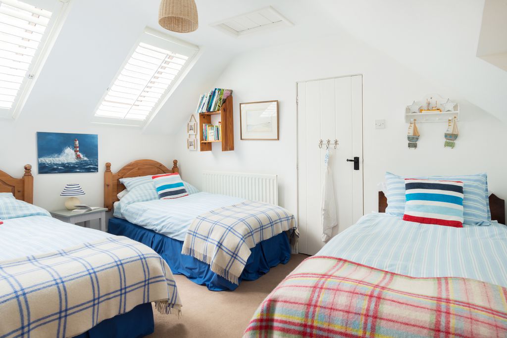 Penpoll's third bedroom with three single beds and continuing seaside theme