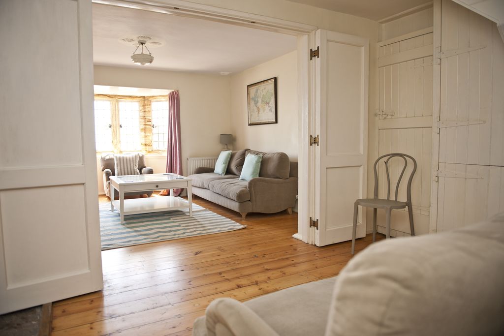 View into the living room with sofas and coffee table at The Sundial 